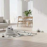 a central vacuum attachment kit for all surfaces: deluxe hose, floor and carpet brush, telescopic wand, upholstery tool, dusting brush, crevice tool, tool caddy and wall hose hanger shown in a bright open living and dining space with light wood floors