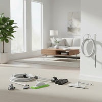 the deluxe electric central vacuum attachment kit: PN33 power nozzle, hose, floor brush, microfiber mop, upholstery tool, crevice tool, tool caddy and wall hose hanger shown in a contemporary family room with large windows and a low-pile beige carpet